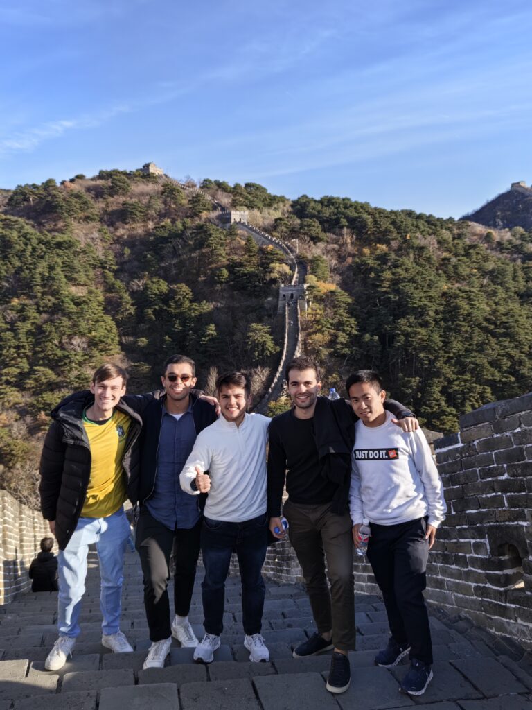 Students taking a group photo on the Great Wall of China during their business trip.