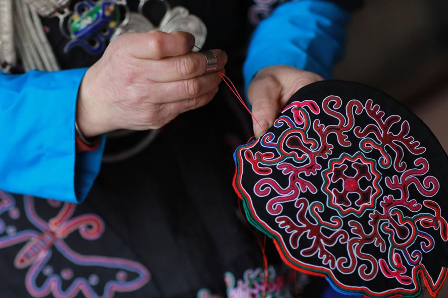 Learning Miao embroidery and silverwork on a cultural heritage school trip to rural China.