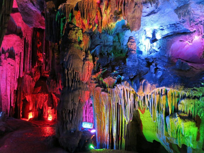 Students explore a karst cave in Yangshuo, China, during a school trip focused on adventure and natural landscapes.