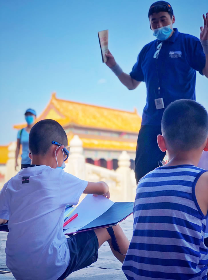 Educational activity near the Hall of Supreme Harmony, where students explore the Forbidden City’s layout through mapping.