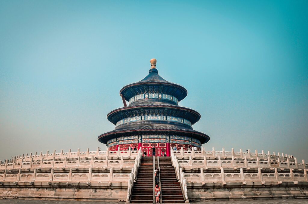 Students engaging in morning activities with locals at the Temple of Heaven in Beijing during a school trip to China