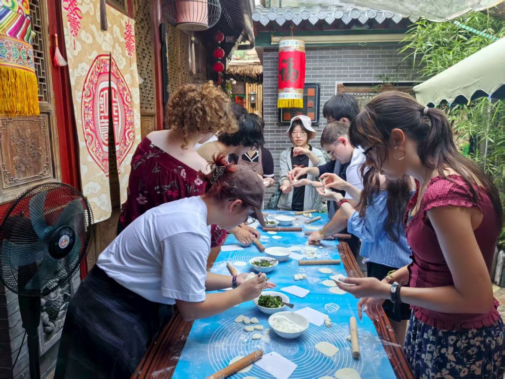 Students during a hands-on dumpling cooking class in China.
