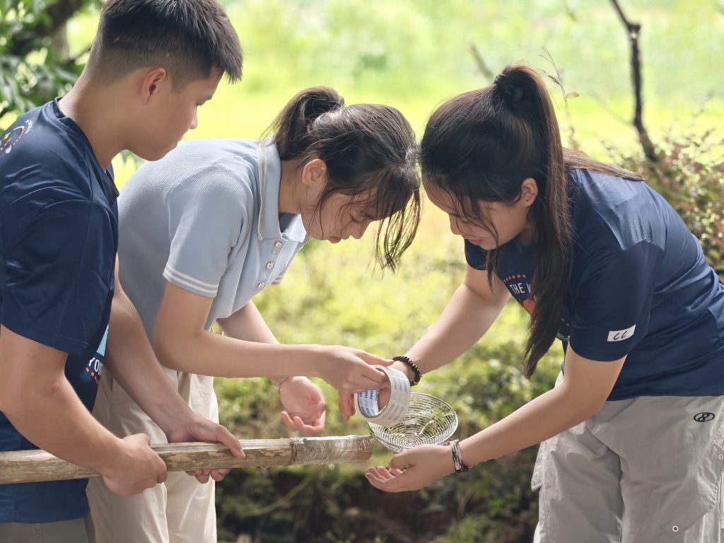 School trip leader helping students.
