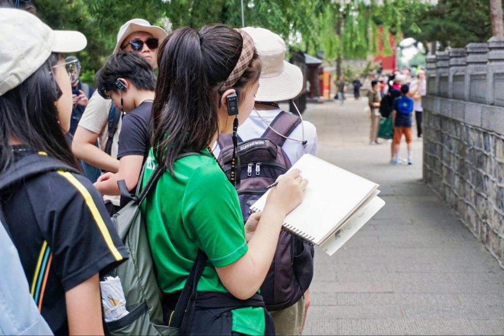 Students taking notes during a site visit and activity