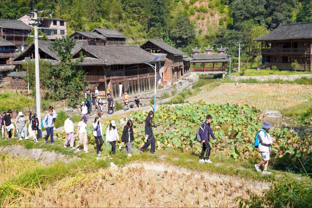 Students exploring terraced farmland and rural landscapes in China.