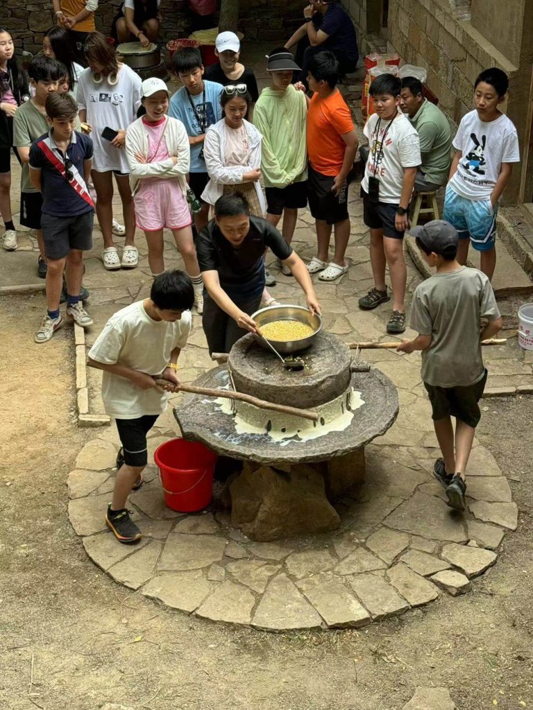 Students interacting with local residents during an educational program in rural China.