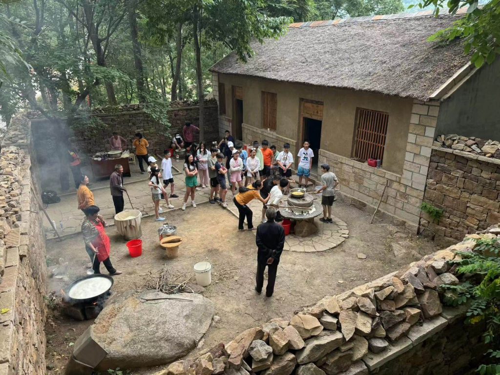Students observing village life and local traditions in rural China.