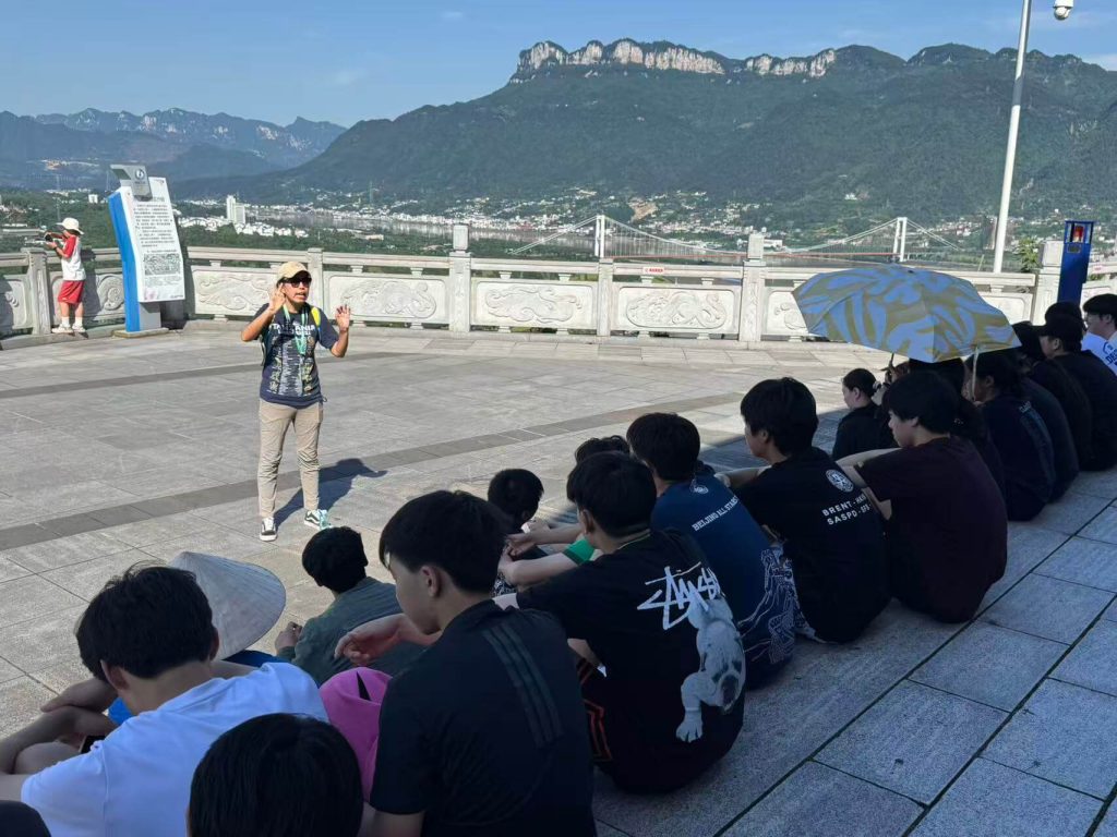 Students studying the Yangtze River and riverfront land use during an educational trip in China.