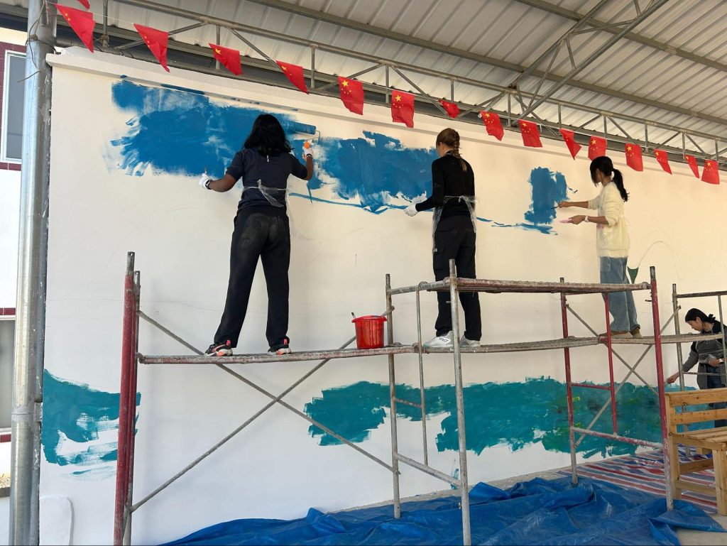 Students participating in a hands-on community activity during an educational trip in China.