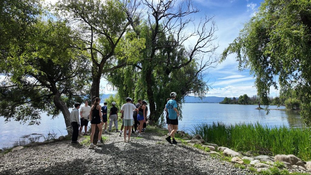 Students taking part in a biodiversity workshop beside a lake in Yunnan, China.